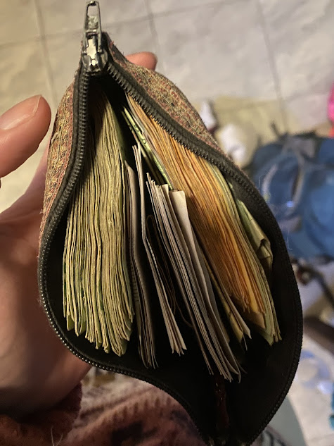 How much does it cost to travel to Argentina? A bundle of pesos bursting from a purse.
