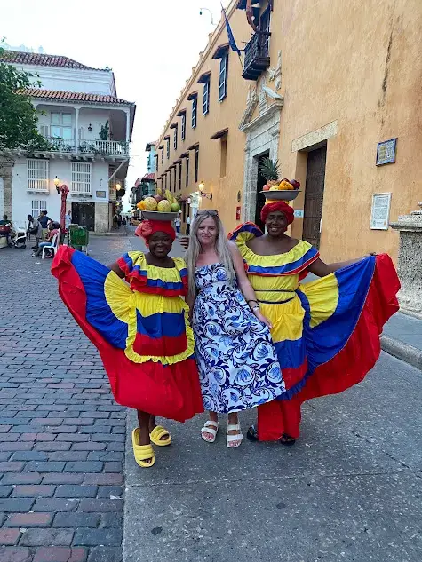 Is Cartagena safe? Colombian women posing for a photo in traditional outfits. 