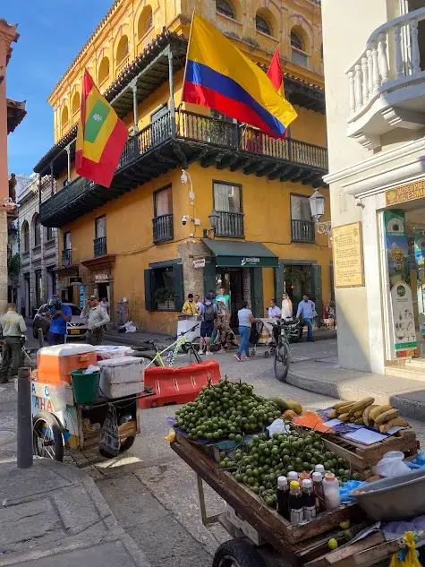 Is Cartagena safe? Fruit stalls and the Colombian flag on display on a street in the Walled City.